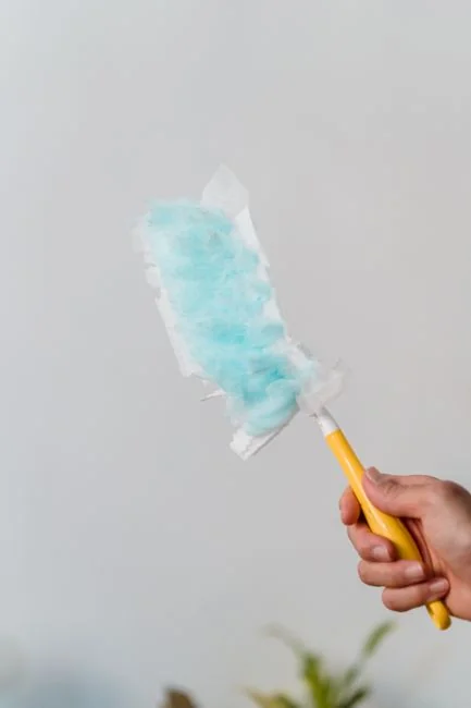 A clean and organized home office desk with a cleaner bottle and sponge, emphasizing simplicity and functionality.